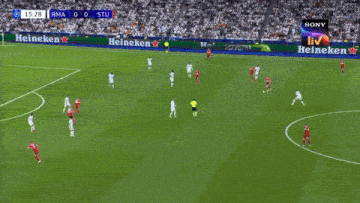 a soccer game is being played in front of a large heineken advertisement