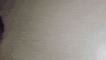 a close up of a person 's face on a white wall