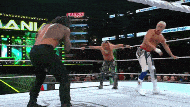 three wrestlers in a ring with a sign that says firstrust