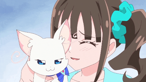 a girl holding a white cat with a blue bow on it