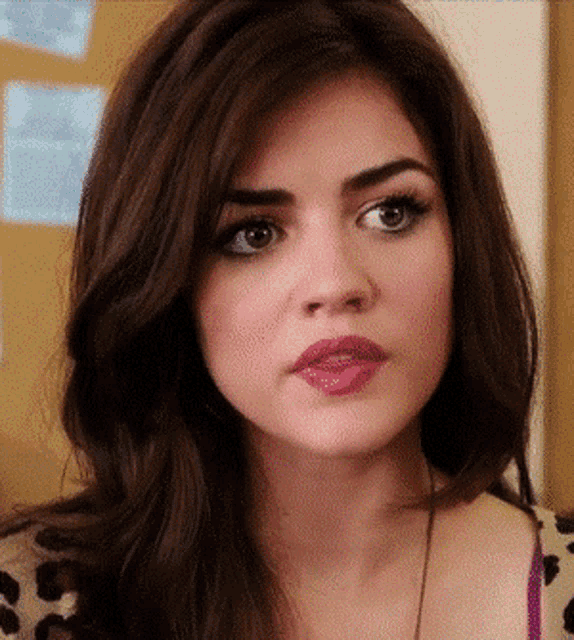 a close up of a woman 's face with brown hair