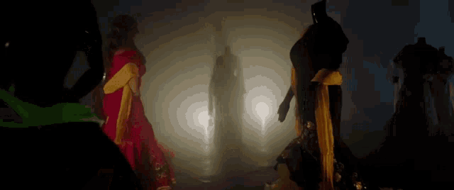 a group of mannequins are standing in a dark room
