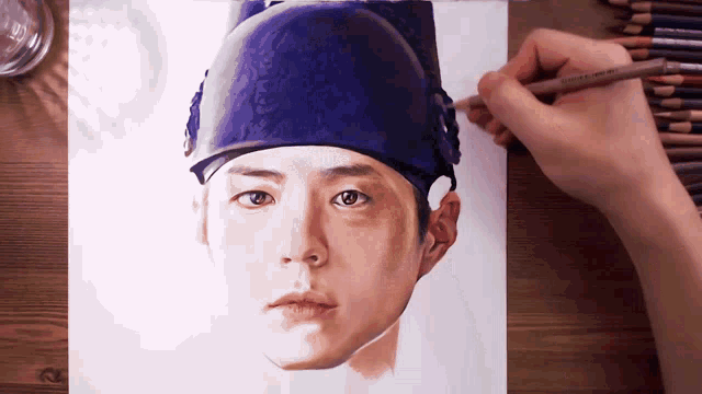 a person is drawing a man 's face with colored pencils that say prismacolor