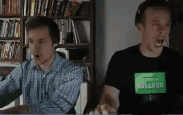 a man wearing a shirt that says ' pracownik kollega ' on it is screaming