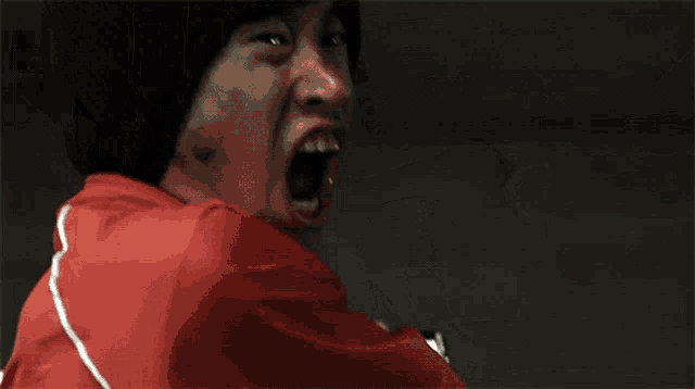 a man in a rhino costume holds a red light saber