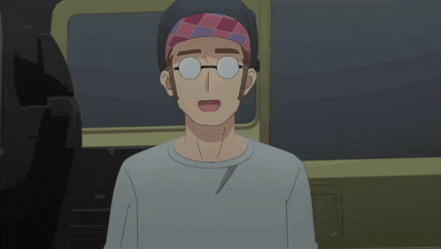 a man wearing glasses and a headband is standing in a car