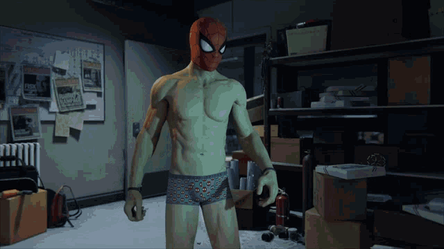 a man in a green spiderman costume stands in a room