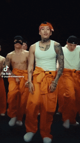 a group of men in orange jumpsuits are dancing in a tiktok