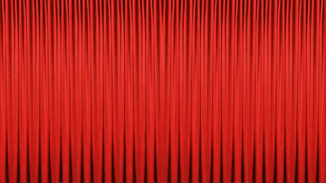 two statues are behind a red curtain with the word ram on it