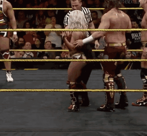 a group of wrestlers are in a ring and one of them is wearing a shirt that says bald eagle on it
