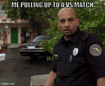 a police officer is pulling up to a vs match on a parking lot