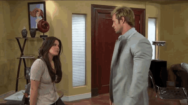 a man and a woman are standing next to each other