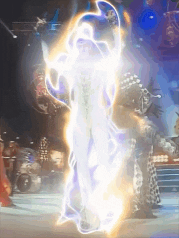 a person is surrounded by a glowing light while standing on a stage