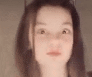 a blurry picture of a woman 's face with a cat ear .
