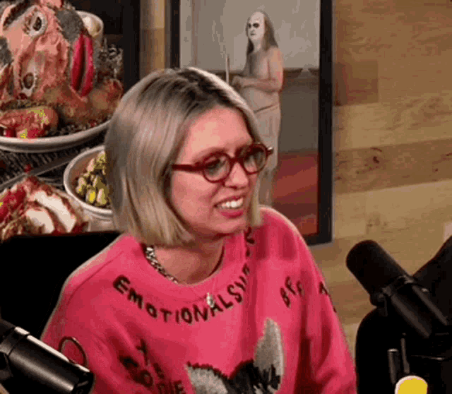 a woman wearing a pink sweater that says " emotionally bff "