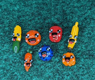 a group of vegetables with faces on them are sitting on a green carpet .