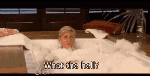 a woman is laying in a bathtub with bubbles and says what the hell