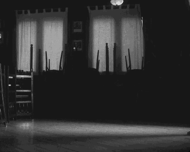 a man and a woman are dancing in a black and white photo