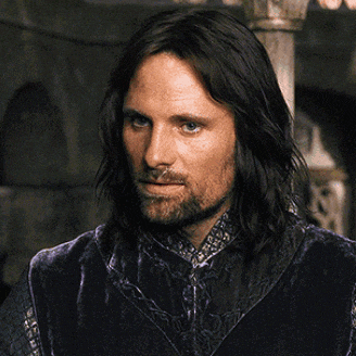 a man with long hair and a beard is looking down