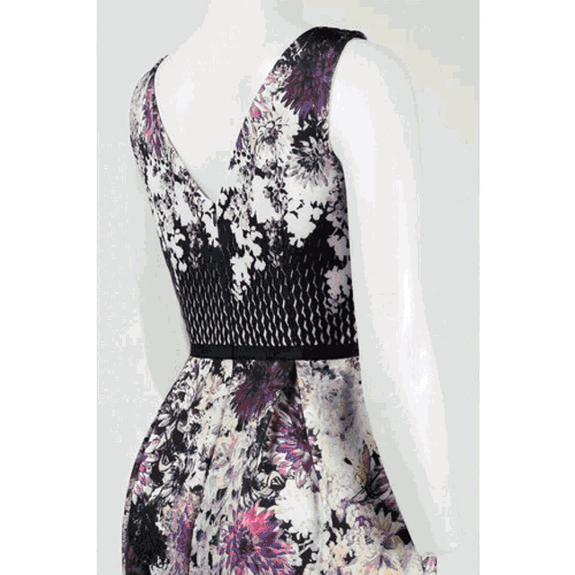 a mannequin wearing a black and purple floral dress