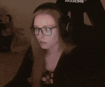 a woman wearing glasses and headphones says " do n't fuckin look at me "