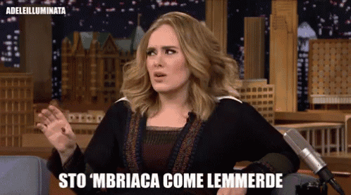 a woman sitting in front of a microphone with the words sto mbriaca come lemmerde on the bottom