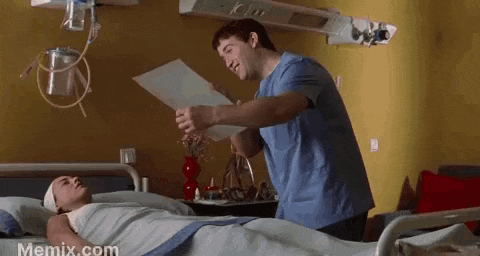 a doctor is standing next to a patient in a hospital bed .