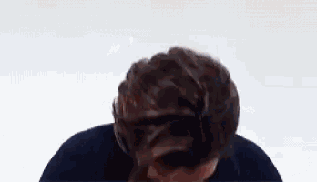 a close up of a person 's head with a bun on it .