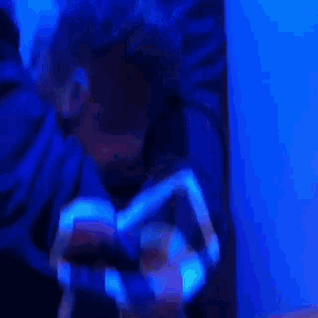 a person wearing a glow in the dark shirt is holding a piece of paper
