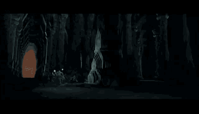 a group of people are fighting each other in a dark room in a black and white photo .