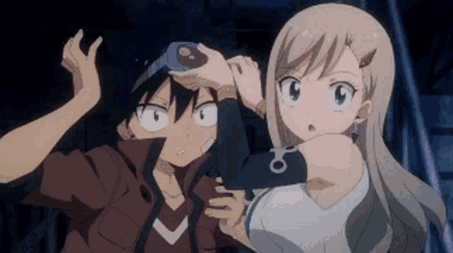 a boy and a girl are standing next to each other .