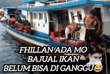 a man wearing a mask stands in front of a boat that says fhillan ada mo bajul ikan belum bisa di ganggu