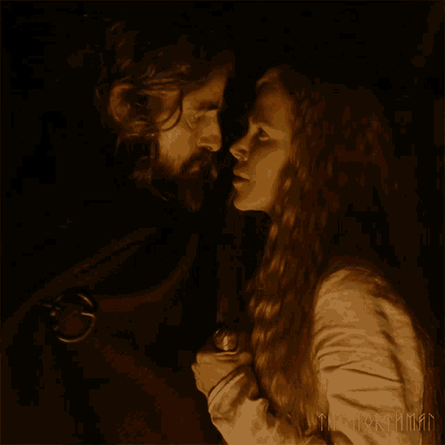 a man and a woman are looking at each other and the words the northman are on the bottom