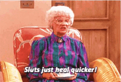 an elderly woman is sitting in a chair holding a cup of coffee and saying sluts just heal quicker .