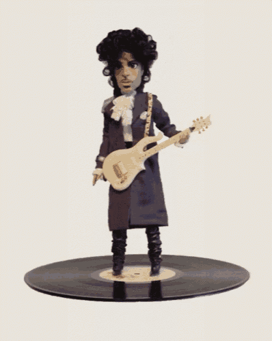 a figurine of prince is holding a guitar