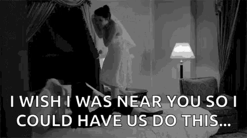 a black and white photo of a bride and groom in a bedroom with a quote .