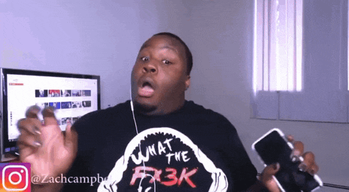 a man wearing a black shirt that says what the fk3k