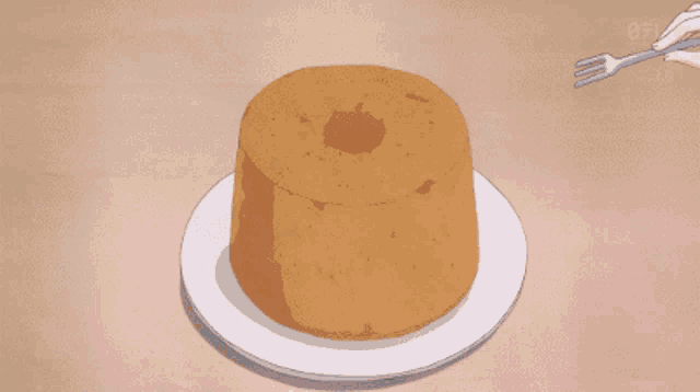 a person is holding a fork over a chiffon cake on a plate
