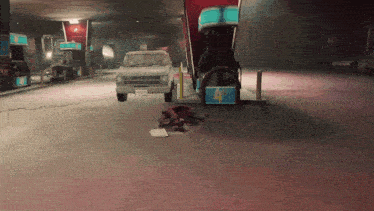 a car is parked in front of a gas station with a sign that says 4