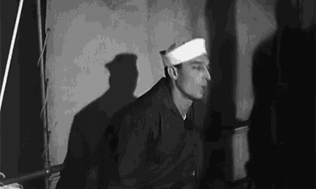 a man with a bandage on his head in a black and white photo .