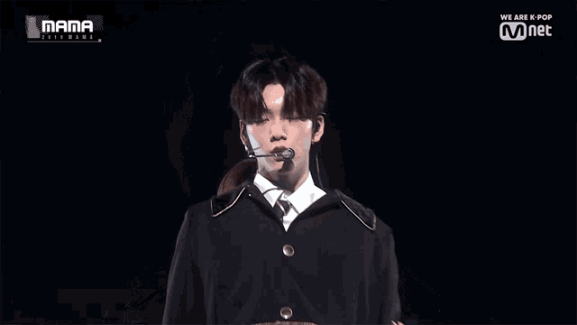 a man singing into a microphone with the words mama on the bottom right