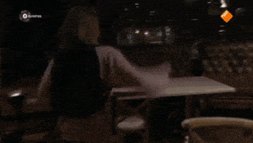 a group of people are dancing in a living room with a tv behind them that says ' npo ' on it