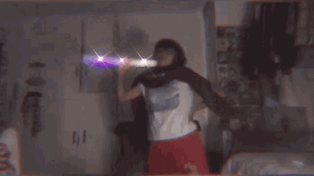 a person wearing a supreme shirt is taking a selfie in a dark room