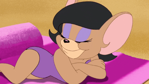 a cartoon mouse is laying on a pink blanket
