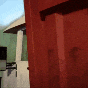 a red door is open to a white room