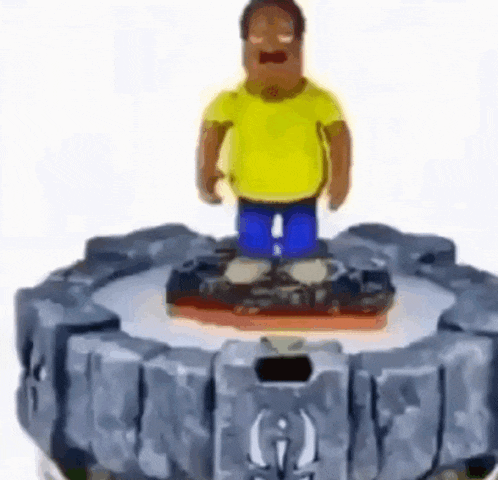 a man in a yellow shirt and blue pants is standing on top of a toy .