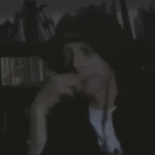 a blurry picture of a person wearing a hat and a white shirt