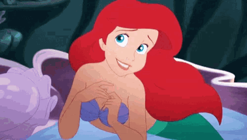 ariel from the little mermaid is smiling in a cartoon