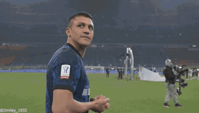a soccer player wearing a jersey with an italian emblem on it covering his mouth with his hands