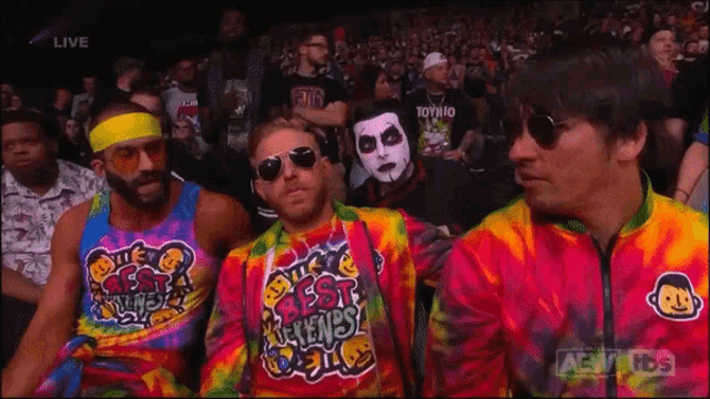 a group of men wearing tie dye shirts that say best friends